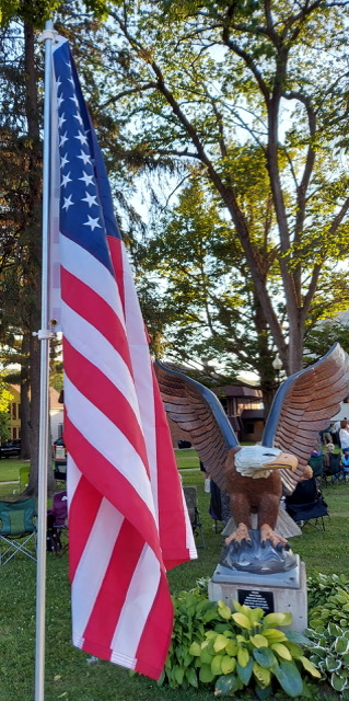 Bald Eagle – Symbolizes Pride

CHARACTERISTICS -National Symbol.  Eagles can fly up to 30 m.p.h. and can dive at speeds up to 100 m.p.h.; eagles learn to fly at three months of age and can live 30 years or more in the wild.   
Sculptor- David Oswald
Sponsored & Painted by Pat & Jim Discher